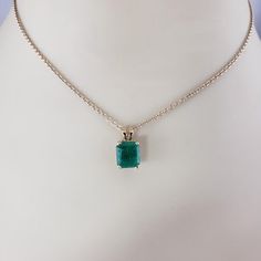 14K Yellow Gold Emerald Pendant JAGi Certified  This stunning pendant features one emerald cut natural emerald (8.6 mm x 7.5 mm) set in classic 14K yellow gold.  Emerald weight: 2.02 ct.  Size: 14 mm x 7.5 mm  Stamped: 14K  Weight:  0.8 dwt./ 1.25 gr.  JAGi Certificate included.  *Chain not included.  Very good condition, professionally polished.  Will come packaged in a gift box or pouch (when possible) and will be shipped U.S. Priority Mail Insured. Classic Yellow Gold Emerald Cut Necklace, Classic Gold Emerald Cut Emerald Necklace, Classic Emerald Cut Emerald Necklace For May Birthstone, Classic 14k Gold Emerald Cut Emerald Necklace, Classic Gold Emerald Cut Necklace, Gold Emerald Cut Emerald Necklace, Fine Jewelry Gold Emerald Cut Emerald Necklace, Emerald Cut Emerald Necklace For May Birthstone, Gold Emerald Cut Necklace In Fine Jewelry Style