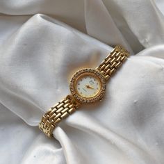 Women's EJ gold toned clasp band style watch. gold circular face with silver numbers and gold hands. Approximately 7.75 inches - rhinestone details around and on the face . TICKING/WORKING - new battery Cleaned, polished, refurbished, and tested to the best of my ability. coastal grandmother, coastal granddaughter, clean girl, vanilla girl, old money, coquette, soft girl, lo fi, maximalist, y2k, sad girl, twee, academia, plazacore, whimsigoth, weird girl, fairycore, kidcore, gorpcore, minimalist, retro, indie, skater, baddie, techwear, cottage core, dark academia, barbiecore, angelcore, balletcore, coastal cowgirl, countrycore, preppy, craftcore, normcore, vacationcore, europecore, italycore, quiet luxury, vintage, avant garde Metal Diamond Watch, Metal Diamond Watch With Metal Dial, Diamond Watch With Metal Dial, Gold Diamond Watch With Metal Round Dial, Gold Analog Diamond Watch, Gold Metal Jewelry And Watches With Round Dial, Metal Diamond Watch With Diamond Hour Markers, Gold Analog Diamond Watch With Round Dial, Gold Diamond Analog Watch With Round Dial