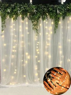 a large ball sitting in front of a curtain with lights hanging from it's sides