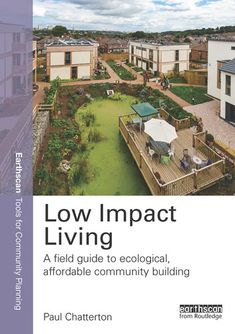 a book cover with the title low impact living, including an aerial view of houses and gardens