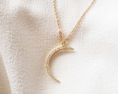 "24K gold-filled 29mm cubic zirconia crescent moon pendant 14K gold-filled 2.5mm flat cable chain 14K gold-filled 10mm Italian teardrop lobster clasp NOTE: Gemsicles' gold-filled jewelry is cadmium-free, lead-free and nickel-free. :) NOTE: This listing is for one necklace with one pendant, but you can choose to purchase just the pendant without the chain (see drop down menu). The \"Pendant - No Chain\" option includes the pendant with a bail/top loop and no chain. Fast and free shipping US selle Gold Necklace With Moon Charm In Cubic Zirconia, Gold Necklace With Moon Charm And Cubic Zirconia, Gold Moon-shaped Jewelry With Cubic Zirconia, Gold Moon-shaped Cubic Zirconia Jewelry, Moon Shaped Gold Cubic Zirconia Jewelry, Rhodium Jewelry, Etsy Boutique, Buying Gold, Crescent Moon Pendant