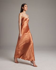 Named by Vogue as a must-have, this easy to wear luxury charmeuse slip dress is the perfect day to night staple. Featuring a bias cut and the finest silk quality, it shapes flatteringly to every type of body. Bias cut silk charmeuse slip elegantly drapes on the body. 100% Silk Charmeuse Made in New York City Model is wearing a size S and is 5'10.5" Product Care: Dry Clean Only City Model, Silk Dress Long, The Perfect Day, Silk Slip Dress, Boatneck Sweater, Silk Tank, Silk Slip, Silk Charmeuse, Perfect Day