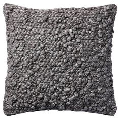 a gray and white pillow on a white background