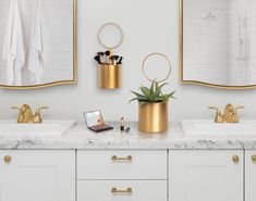 the bathroom is decorated in white and gold with marble countertops, two sinks, and mirrors