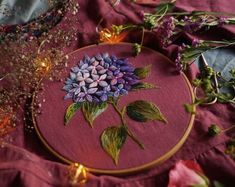 a close up of a embroidery on a table with flowers