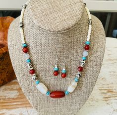 Beautiful red and white agate beads combine with carnelian, turquoise Howlite, and Dalmatian jasper beads in this choker necklace with a Southwestern flair. Matching earrings dangle 1 inch from ear wires. Southwestern Red Jewelry With Natural Stones, Southwestern White Round Beads Jewelry, Southwestern White Round Bead Jewelry, White Southwestern Style Round Bead Jewelry, Southwestern Style White Round Beads Jewelry, Adjustable Carnelian Jewelry With Colorful Beads, Southwestern Red Jewelry With Gemstone Beads, Southwestern Style Red Jewelry With Gemstone Beads, White Southwestern Turquoise Necklace Gift