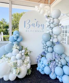 blue and white balloons are on display at the baby blechman event in front of a large sign