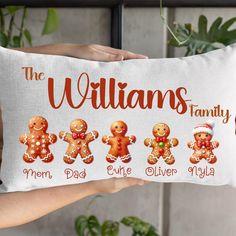 a person holding up a pillow with gingerbreads on it and the words, the williams family