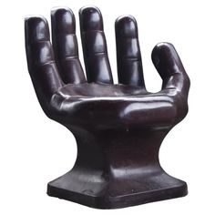 a black hand statue is shown against a white background