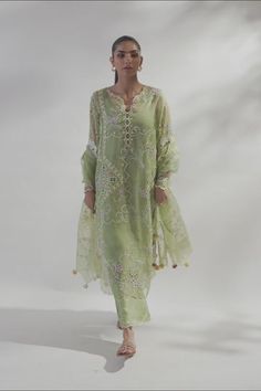 "A timeless organza shirt and dupatta are rendered with a playful fusion of cutwork and signature SM floral embroidery in pastel shades over a lemon green base. Rawsilk trousers with scalloped edges and tassel detailing complement the look.                                      Model Specifications:Model height: 5'10Len Green Sets With Dupatta For Spring, Spring Pista Green Kurta With Sheer Dupatta, Pista Green Kurta With Sheer Dupatta For Spring, Green Sets With Sheer Dupatta For Spring, Spring Pista Green Silk Sets, Summer Organza Lawn Suit With Dupatta, Spring Pista Green Salwar Kameez With Sheer Dupatta, Summer Lawn Suit With Sheer Dupatta, Pista Green Salwar Kameez With Sheer Dupatta For Spring