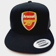 a black and red hat with the word arsenal on it's front