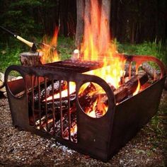 an outdoor fire pit with flames and logs