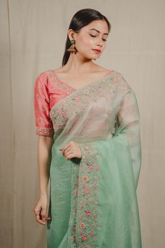 Mint green organza saree with floral and pearl embroidered scalloped borders. Comes with a raw silk blouse embellished with zari and pearl threadwork.
Component: 2
Pattern: Embroidered
Type Of Work: Pearl, Threadwork, Zari, Zardozi
Neckline: Sweetheart
Sleeve Type: Half
Fabric: Saree: Organza, Blouse: Raw Silk
Color: Green,Pink
Other Details: 
Weight: 1-2 kgs
Attached lining
Embroidered border
Occasion: Reception,Sangeet - Aza Fashions Embroidered Organza Blouse For Wedding, Pista Green Organza Saree For Wedding, Green Chanderi Blouse With Sheer Dupatta, Traditional Pista Green Organza Blouse Piece, Fitted Green Organza Saree, Green Organza Blouse Piece With Zari Work, Green Organza Blouse With Resham Embroidery, Semi-stitched Pista Green Organza Blouse Piece, Pista Green Cotton Silk Blouse Piece For Wedding