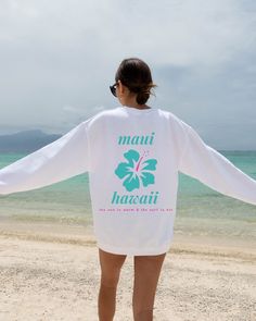 "The perfect chance to wear A Maui Hawaii, the sun is warm and the surf is hot Sweatshirt. This makes a great way to have soft cozy oversized beach travel sweatshirt. For anyone that adores: Hawaii, Hikes, Beach, Ocean, Snorkeling and celebrating Aloha this is for you!  Gildan 18000 Sweatshirt  Unisex Adult Sizing  Listing includes: Sweatshirt Only  50% Cotton, 50% Polyester Made To Order:  This is a Direct-To-Garment item and the ink is printed into the fabric, which prevents cracking and peeli White Screen Print Sweatshirt For Summer, White Letter Print Sweatshirt For Beach Season, White Sweatshirt For Beach Season Vacation, White Tropical Surfing Top, White Letter Print Sweatshirt For Vacation, White Summer Sweatshirt For Beach, White Relaxed Fit Sweatshirt For Beach, White Long Sleeve T-shirt For Beach Season, White Hawaiian Surfing Top