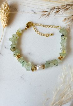 This gold-plated bracelet is made of Prehnite, freshwater pearls and pearls gilded with 18k fine gold. Gems: Prehnite Metal: 18k gold plated on brass Size: 14cm + 6cm (extension chain) Prehnite: A stone of protection and healing, Prehnite is very appreciated in lithotherapy for its relaxing properties. It calms, relaxes and soothes the mind. Prehnite prevents being affected by external evils and bad energies. Whether on a physical or emotional level. Gold Pearl Bracelets With Gemstone Beads, Gold Bracelets With Natural Stones For May Birthstone, Gold Pearl Bracelet With Natural Stones As Gift, Gold Jade Bracelets With Natural Stones, Beaded Jewlery, Gold Plated Bracelets, The Mind, Favorite Jewelry, Freshwater Pearls