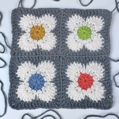 a crocheted square with multicolored flowers on it