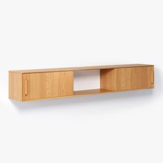 a wooden shelf with two doors on the side