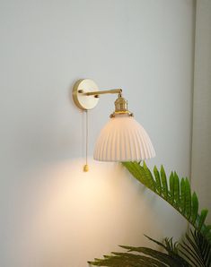 Illuminate your home with elegance and sophistication with our ceramic wall light. With its beautiful ceramic lampshade and brass hardware, our wall light adds an eye-catching touch of style to any room. Our high-quality construction ensures that your light will last for years to come. - Bulb Base - E26/E27 - Voltage 90-240 v - Watts - 60 w - Hardware material - brass - Canopy / wall plate material - brass - Lampshade material - white ceramic - Canopy / wall plate size - 10 cm or 4 inches (12 cm Brass Lampshade, Lampe Art Deco, Concrete Pendant Light, Ceramic Wall Lights, Bedroom Light Fixtures, Sconces Bedroom, Brass Bathroom, Art Deco Lamps, Retro Lighting