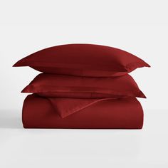 three red pillows stacked on top of each other