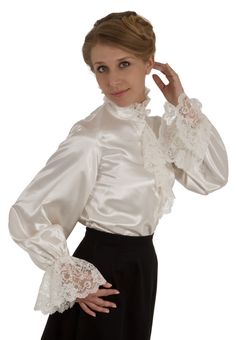 What could be more romantic and feminine than shimmering satin and frothy lace? The satin blouse features an attached lace trimmed jabot and closes with satin-covered buttons, and very full long sleeves with a deep ruffle of lace at the cuff. The blouse has a button closure down the front and comfortable elastic at the wrists. Proudly designed and made in America by Recollections. Poly satin; Dry clean or hand wash.The model finishes the look with a skirt which is priced separately. Formal Blouse With Lace Trim And Ruffled Collar, Elegant Blouse With Lace Trim And Ruffled Collar, Long Sleeve Satin Top For Wedding, Evening Satin Blouse With Ruffles, Formal Lace Blouse With Ruffles, Elegant Lace Blouse With Ruffles, Formal Satin Blouse With Ruffles, Elegant Ruffled Lace Blouse, Elegant Satin Blouse With Ruffles