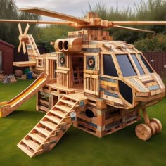 a wooden helicopter with stairs and slide in the grass