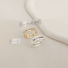 three rings with names on them sitting next to each other