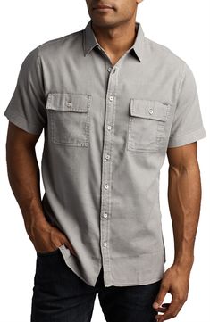 Look like a part-time paleontologist in this rugged washed-twill shirt made from a lightweight cotton-blend ideal for digging in the Gobi desert or lunching in LA. 28" length; 38" chest (size Small) Spread collar Short sleeves 60% cotton, 40% rayon Machine wash, tumble dry Imported Outdoor Khaki Short Sleeve Cotton Shirt, Outdoor Khaki Cotton Short Sleeve Shirt, Casual Washed Linen Shirt, Rugged Cotton Shirt With Button Closure, Utility Style Washed Cotton Tops, Utility Cotton Tops With Washed Detail, Rugged Cotton Button-up Tops, Rugged Pre-washed Cotton Shirt, Rugged Cotton Pre-washed Shirt