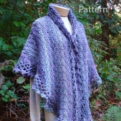 a crocheted shawl on a mannequin in the woods