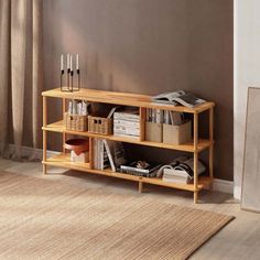 a wooden shelf with baskets and books on it