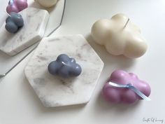 three pieces of marble sitting on top of a table next to scissors and other items