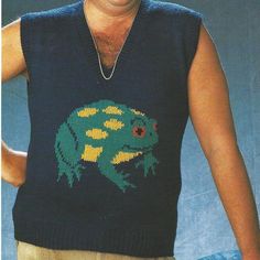 a man wearing a sweater vest with a green frog on it