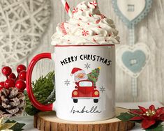 a red and white coffee mug with whipped cream in the shape of a santa clause on it