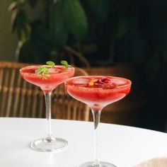 two wine glasses filled with watermelon and garnish