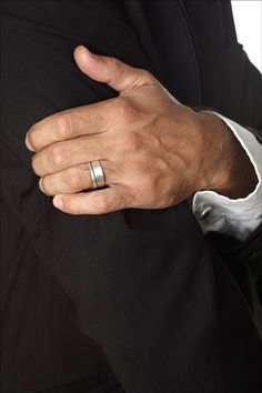 This Unique Men’s Wedding Ring is an ideal solution for the groom who wants to express himself while also staying traditional. This sleek handmade ring features an asymmetrical oxidized silver line, which adds a subtle hint of quirkiness to this classy jewelry item. Because it’s made from 925 sterling silver, it will last a lifetime and is sure to become a family heirloom.This elegant ring is both modern and timeless, so its wearer will always look fashionable and trendsetting. The masculine sty Silver Engagement Rings Men, Man Wedding Ring Silver, Wedding Ring Men Silver, Silver Wedding Rings Men, Mens Silver Wedding Bands, Mens Wedding Rings Unique, Wedding Band Silver, Handmade Wedding Band, Silver Wedding Band