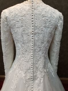 the back of a white wedding dress on display