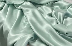 Gorgeous, solid mint green silk with a light shine. One side is shiny, one side is dull.  This fabric makes a beautiful top, Kimono, robe, dress, pajamas...  100% silk, dry clean recommended. Great fabric for apparel. Monitor colors may vary.  Listing is for 1 yard. 36" x 52/53". Wide goods! Light Mint Green Dress, Mint Green Fabric, Dress Pajamas, Light Green Fabric, Prom Dress Inspo, Charmeuse Fabric, Mint Green Dress, Light Mint Green, Dress Inspo