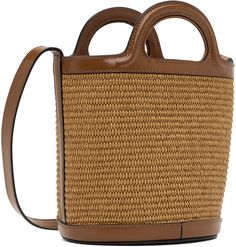 Woven raffia and buffed calfskin top handle bag in tan. Logo embroidered in black at face. · Twin carry handles · Adjustable shoulder strap · Removable twill drawstring pouch at interior · Full twill lining · H7 x W8 x D6.5 in Supplier color: Raw sienna Brown Leather Straw Bag With Dust Bag, Woven Raffia, Drawstring Pouch, Logo Embroidered, Bucket Bag, Calf Skin, Shoulder Strap, Top Handle Bag, Pouch