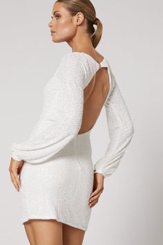 The perfect paradox, the Talei sequin dress by Winona is both poised and playful, with a sophisticated square neckline, elegant long sleeves, and a head-turning open back. A shimmering swath of all-over sequin embroidery and an ultra-mini hemline make her the perfect dress for any dance floor. White micro sequin on a mesh base Lined 100% Polyester Keyhole back Slight stretch fits true to size Glamorous Square Neck Dress For Gala, Glamorous Gala Dress With Square Neck, Elegant Square Neck Sequin Dress, Elegant Backless Dress With Square Neck For Party, Elegant Backless Square Neck Party Dress, Elegant Square Neck Backless Party Dress, Elegant Backless Sequin Dress With Contrast Sequin, Square Neck Sequined Prom Dress, Evening Dresses With Sequins And Square Neck