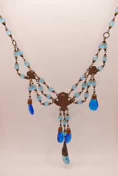 Absolutely stunning genuine antique vintage belle epoch Czech glass festoon necklace. Brass with aged patina in art nouveau goddess motif and sparkling bright aqua blue glass dangle gems. This is an incredible authentic early 20th century statement necklace, a stunning blue piece Good vintage condition. Not upcycled or replicas. This is an antique item, please expect some imperfections. Drop: 37 cm / 14.3 inch ☞ Please view my shipping and sales policies and ✎ Contact me with questions prior to Antique Blue Necklace With Vintage Charm, Blue Antique Jewelry With Antique Finish, Antique Blue Necklaces With Vintage Charm, Belle Epoch, Festoon Necklace, Czech Glass Necklace, Vintage Jewelry Ideas, Art Nouveau Jewelry, Shiny Things