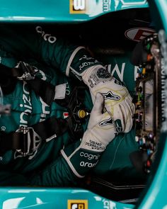 the inside of a racing car with gloves and gear in it's compartment,