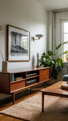 a living room filled with furniture and a painting on the wall over a coffee table