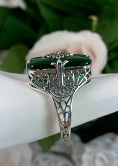 Emerald Green Stone Glass & CZ Ring Grace Design#233 Custom Made I now offer this lovely Antique Art Deco/Edwardian design ring in sterling silver. This gorgeous ring is set with a stunning floral filigree embellished deep emerald green glass/resin with a centered set 1mm white Cubic Zirconia (CZ). The emerald color glass/stone is 18mm Long by 19mm Wide. The ring sits 19mm North South on the finger and 10mm East West on the finger. The inside of the band is marked 925 for sterling. Notice th Silver Art Deco Emerald Wedding Ring, Art Deco Silver Emerald Wedding Ring, Green Sterling Silver Art Deco Jewelry, Silver Gemstone Jewelry In Art Nouveau Style, Art Deco Green Jewelry With Accent Stones, Polished May Birthstone Jewelry For Weddings, Art Deco May Birthstone Jewelry For Formal Occasions, Art Nouveau Sterling Silver Jewelry For Formal Occasions, Art Nouveau Sterling Silver Wedding Jewelry