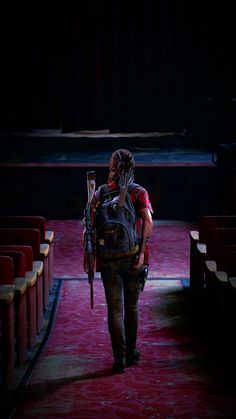 a person walking down a red carpeted aisle with a backpack on it's back