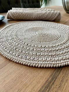 a round rug is sitting on a wooden table