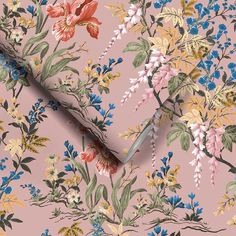 a pink floral wallpaper with blue, yellow and red flowers on the left side