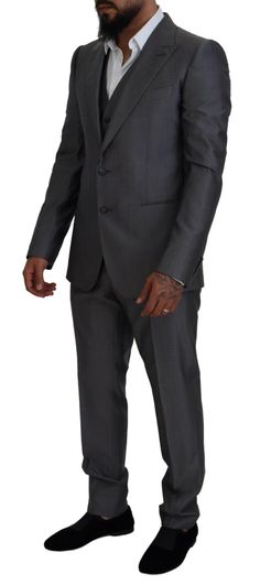 Dolce & Gabbana Sicilia Suit in Dark Gray: Single breasted, slim fit 3-piece suit with blazer, pants, and vest in luxurious Italian wool and silk blend. Features two button closure, two inside pockets, one open vent in the back, and 3-way pants zipper closure. Lined with high-quality materials for an exclusive and expertly crafted look. Color: Gray silver solid Model: Sicilia Style: Single breasted 3 piece suit; includes blazer and pants and vest Closure: Two button closure Fitting: Slim Fit Two Dolce And Gabbana Suits, Costume Gris, Formal Loafers, Slim Fit Suit, Boot Pumps, Dolce E Gabbana, 3 Piece Suits, Blazer Buttons, Premium Brands