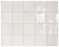 a white tile wall with several square tiles