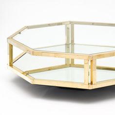 a glass and wood coffee table sitting on top of a white floor