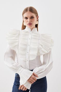 A Blend Of Feminine Charm And Intricate Design, Pleats And Ruffles Elevate This Piece With Texture And Dimension Throughout. Long Cuffed Sleeves Are Enlivened With A Playful Ruffle Detail, This Dramatic Accent Adds Movement And Flair. A High Neckline Adds A Classic Touch. Pair This Shirt With Simple Straight Leg Jeans To Achieve A Balanced Look That Ensures This Piece Remains The Main Attraction.