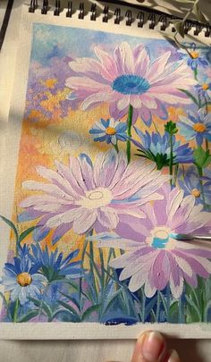 someone is painting flowers with colored pencils